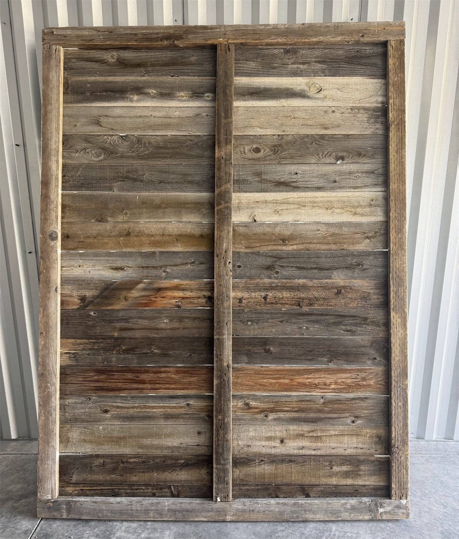 A bare barnwood backdrop panel before styling