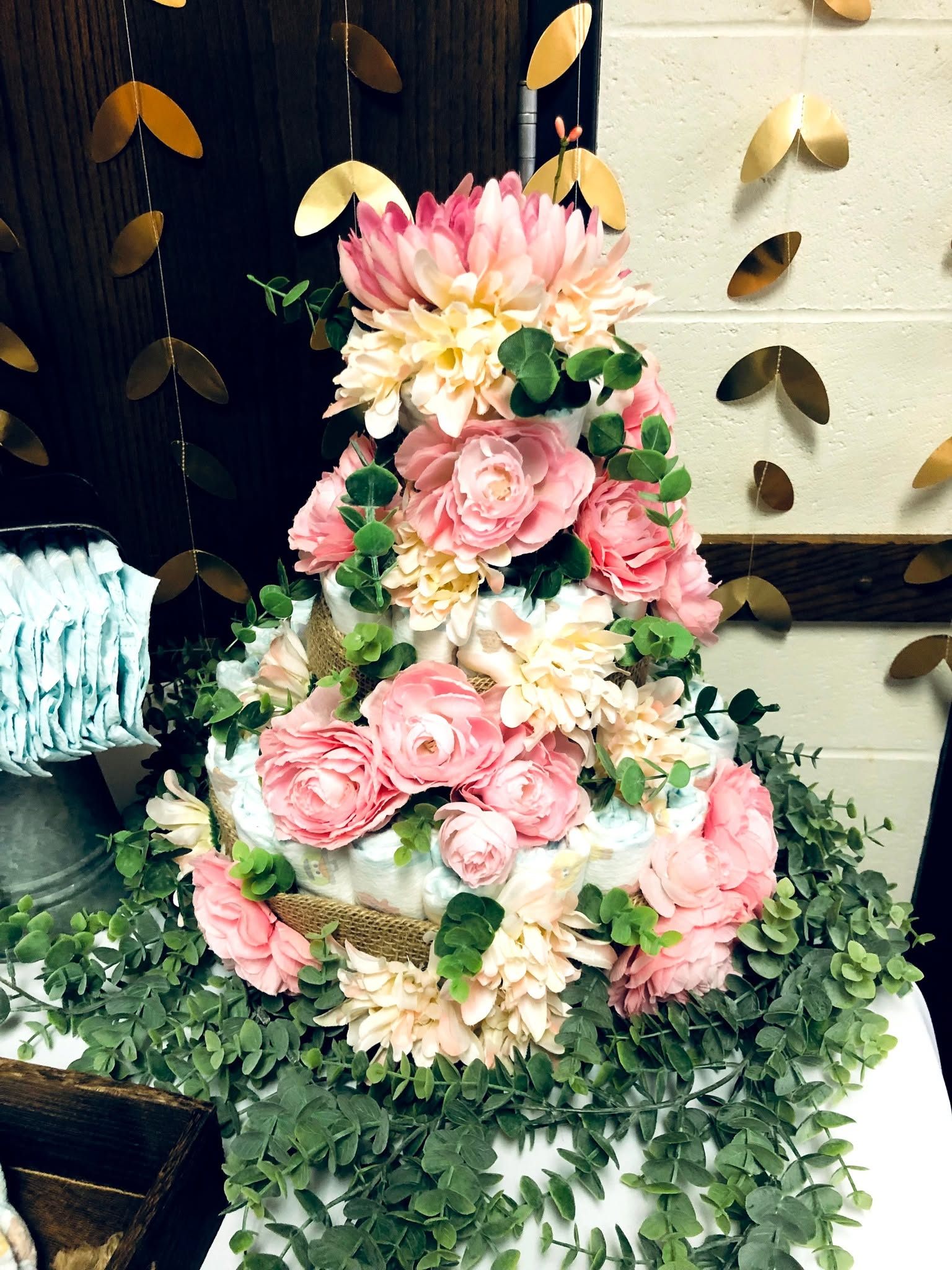 Three tier floral diaper cake with pink roses and eucalyptus