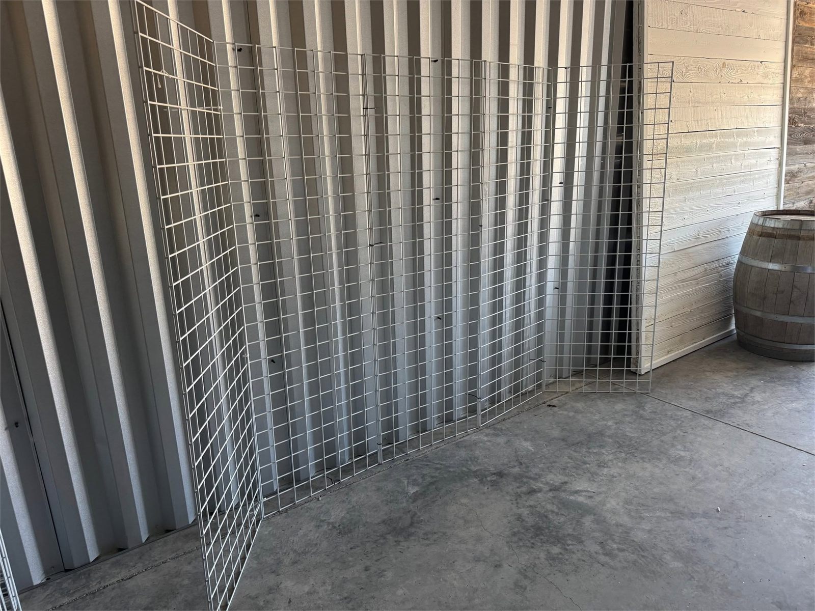 Grid panels stored beside a whiskey barrel in the warehouse