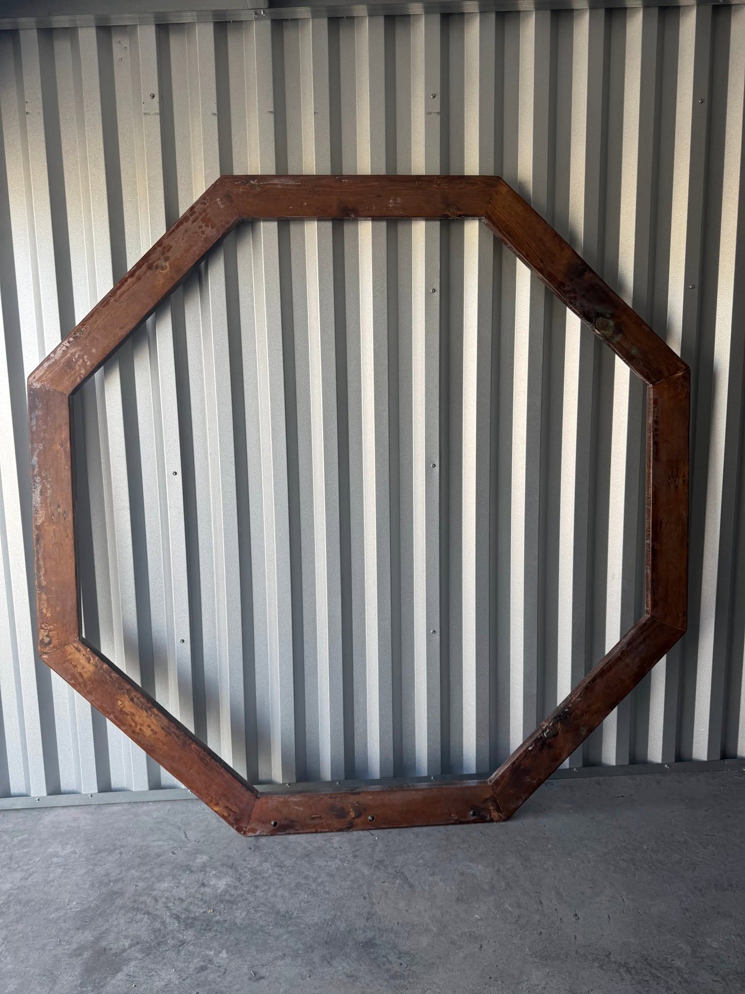 Stained octagon wooden backdrop frame available to rent