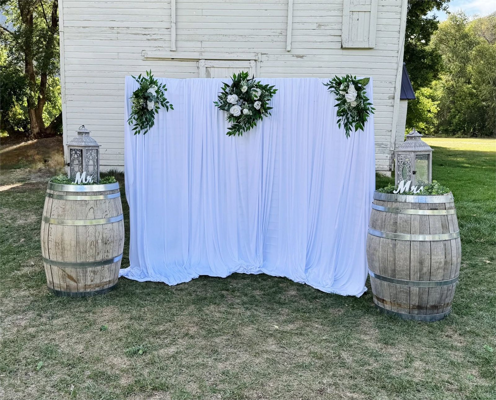 Wedding ceremony backdrop with whiskey barrels styled by Events with Ellee